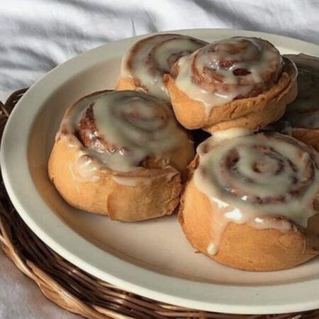 A plate of cinnamon rolls topped with icing (yum yum yum!!)
